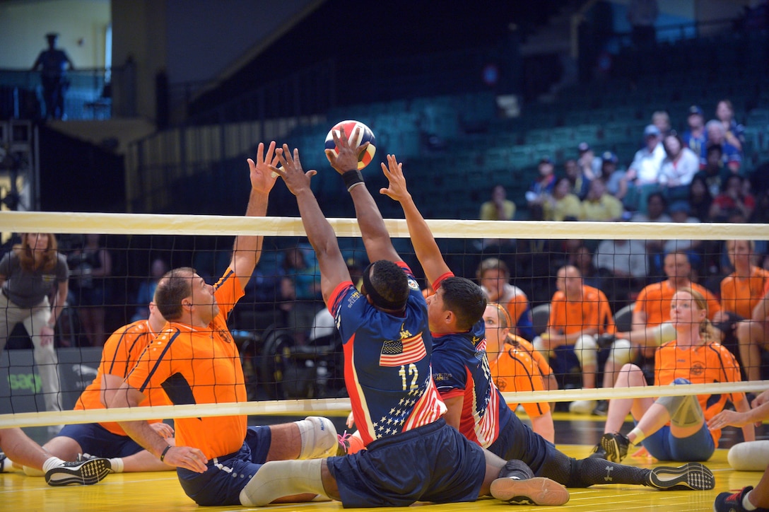 Athletes from the U.S. and Denmark compete in a sitting volleyball match at the 2016 Invictus Games in Orlando, Fla., May 10, 2016. Army photo by Staff Sgt. Alex Manne