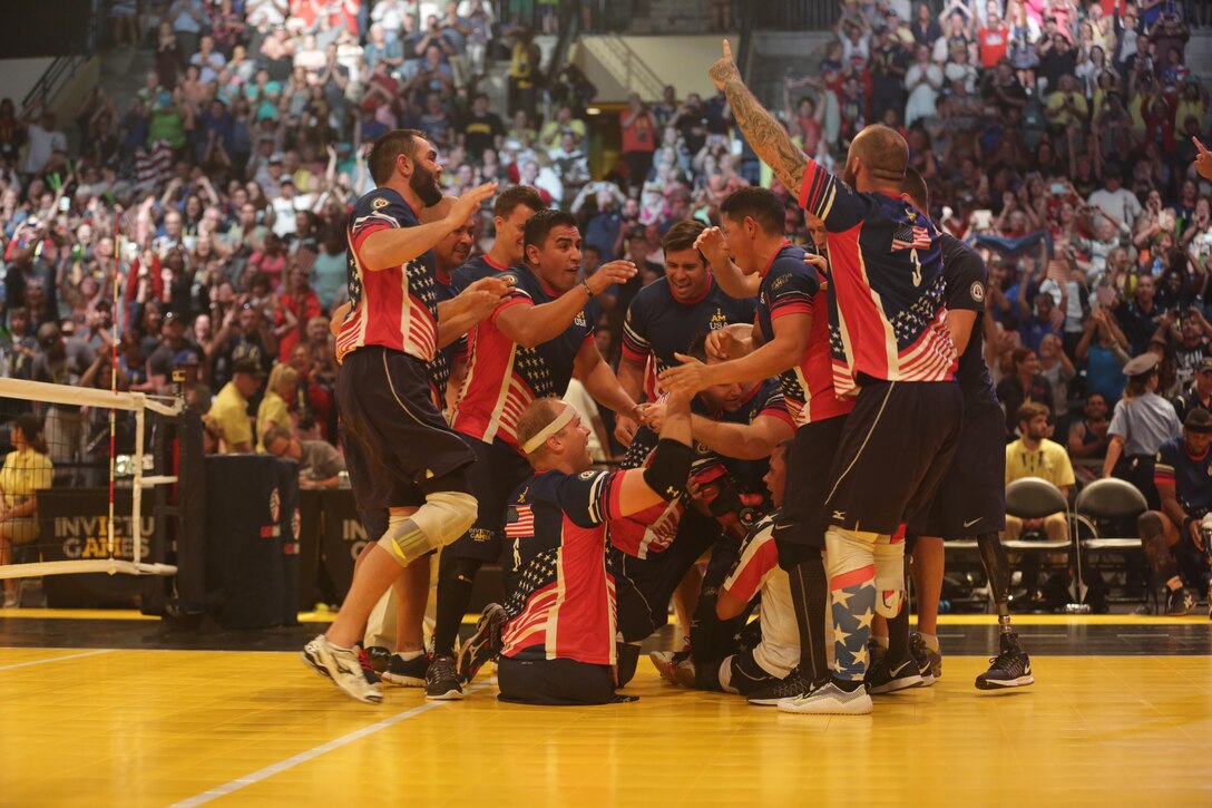 Members of the U.S. team celebrate after beating Great Britain for the sitting volleyball gold medal during the 2016 Invictus Games in Orlando, Fla., May 11, 2016. Army photo by Sgt. Jason Edwards