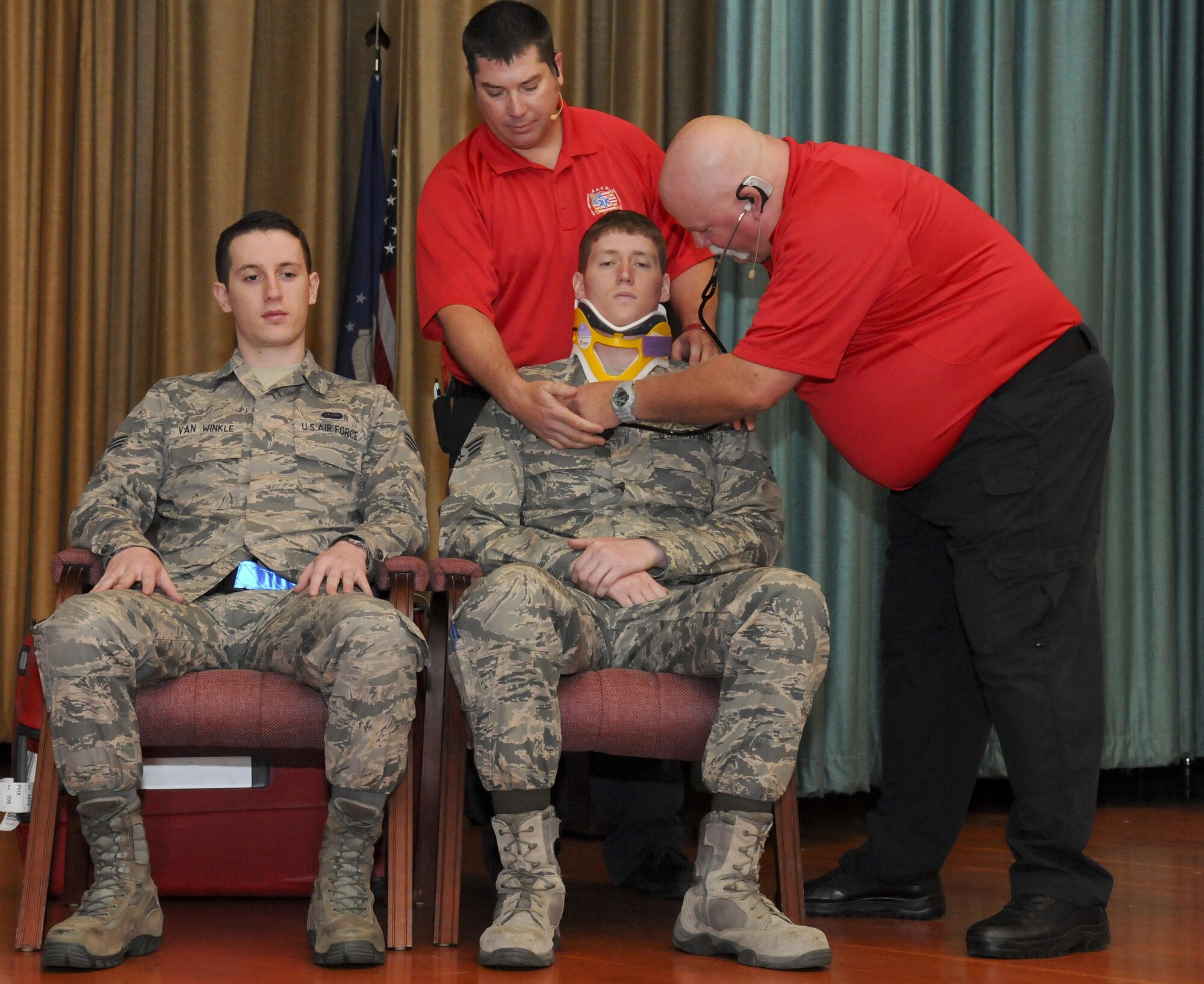 Greg McCarty (Right) and David Dittman (Top) Florida Stay Alive From Education (S.A.F.E.) Inc. presenters, perform a simulated medical examination of SrA Newton Chapman (Center) and SrA David Van Winkle (Left), 9th Aircraft Maintenance Squadron network management technicians, at Independence Hall on Beale Air Force Base, California, May 11, 2016. Chapman and Van Winkle were part of a simulated car wreck during the Tragedy Can be Avoided event. (U.S. Air Force photo by Senior Airman Michael J. Hunsaker)