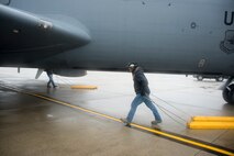 Members of the 459th Maintenance Group drag chocks to the wheels of a KC-135R Stratotanker outside of the DC Air National Guard hangar on the Joint Base Andrews flight line May 5. Members of the 459th Operations Group and 459 MXG setup the aircraft to serve as a static display for the USO's 75th birthday celebration. (U.S. Air Force photo by Staff Sgt. Kat Justen)