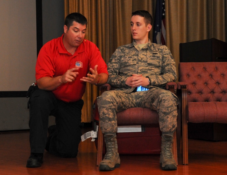 David Dittman (Left) Florida Stay Alive From Education (S.A.F.E.) Inc. presenter, explains a scenario to SrA David Van Winkle, 9th Aircraft Maintenance Squadron network management technician, at Independence Hall on Beale Air Force Base, California, May 11, 2016. Van Winkle performed as a casualty for a simulated car wreck during the Tragedy Can be Avoided event. (U.S. Air Force photo by Senior Airman Michael J. Hunsaker)