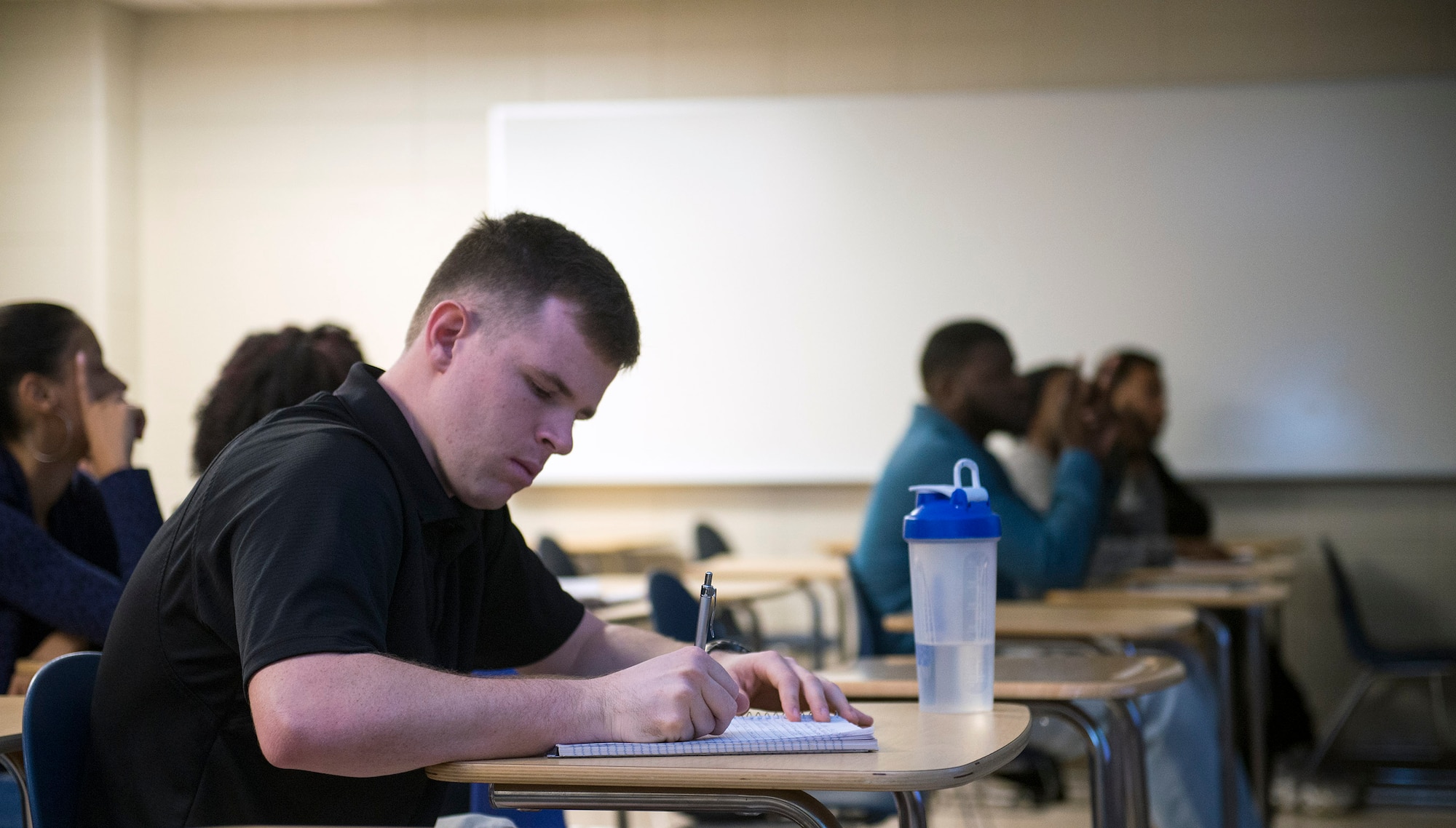 Cadet Col. Bradley Joyal, Air Force ROTC Detachment 172 cadet wing commander, takes notes during class at a local college, Nov. 16, 2015, in Valdosta, Ga. Joyal completed his aspirations of commissioning as a combat systems officer in the U.S. Air Force after earning a degree in criminal justice and graduating in May. (U.S. Air Force photo by Airman 1st Class Greg Nash/Released)