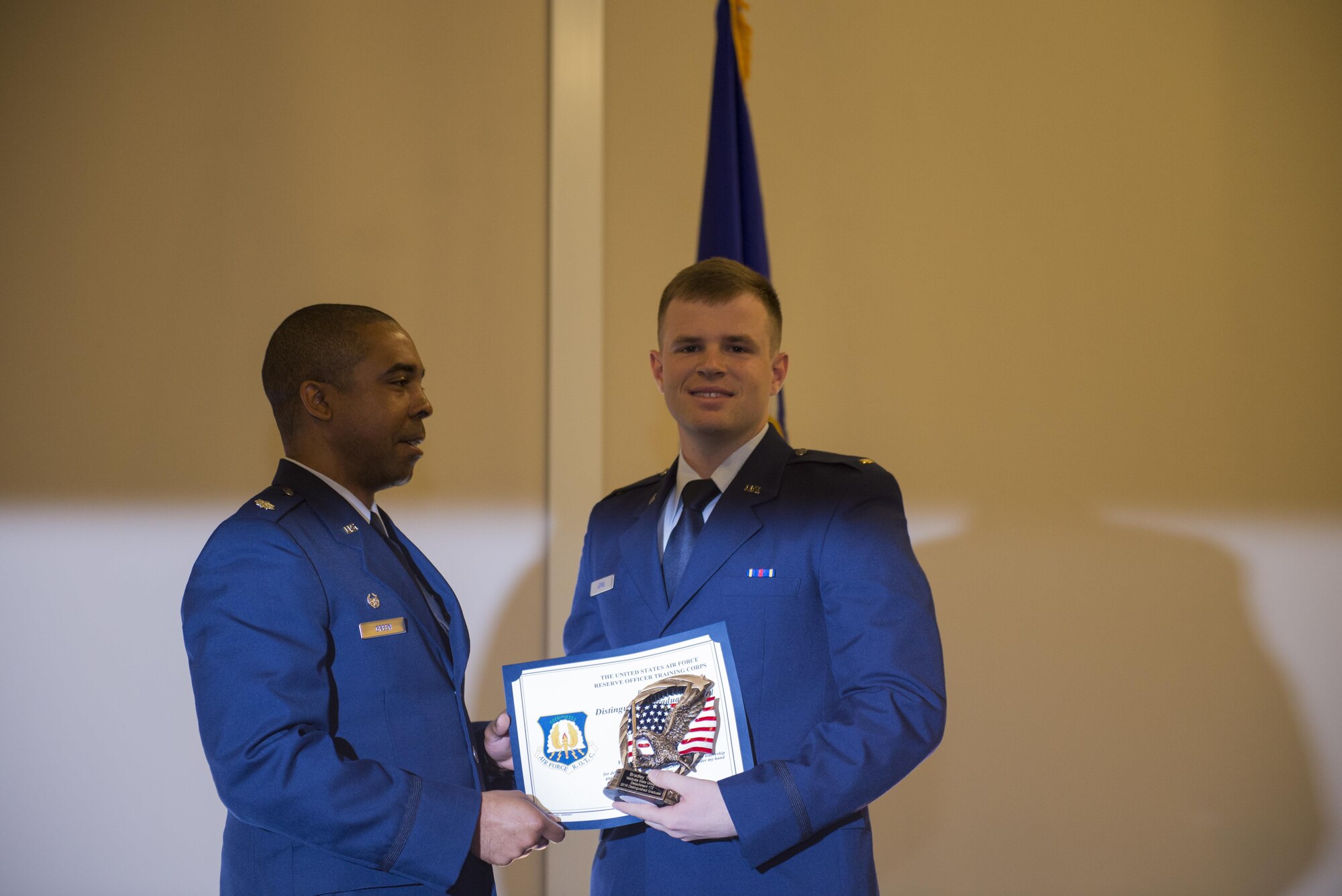 U.S. Air Force Lt. Col. Melvin Green, Detachment 172 commander, presents 2nd Lt. Bradley Joyal, former Air Force ROTC Det. 172 cadet wing commander, with the 2016 Det. 172 Distinguished Graduate award, May 7, 2016, in Valdosta, Ga. Joyal was awarded for his exceptional work as a cadet and student, and will embark on his active-duty Air Force journey to complete combat systems officer training at  Naval Air Station Pensacola, Fla. (U.S. Air Force photo by Airman 1st Class Greg Nash/Released) 
