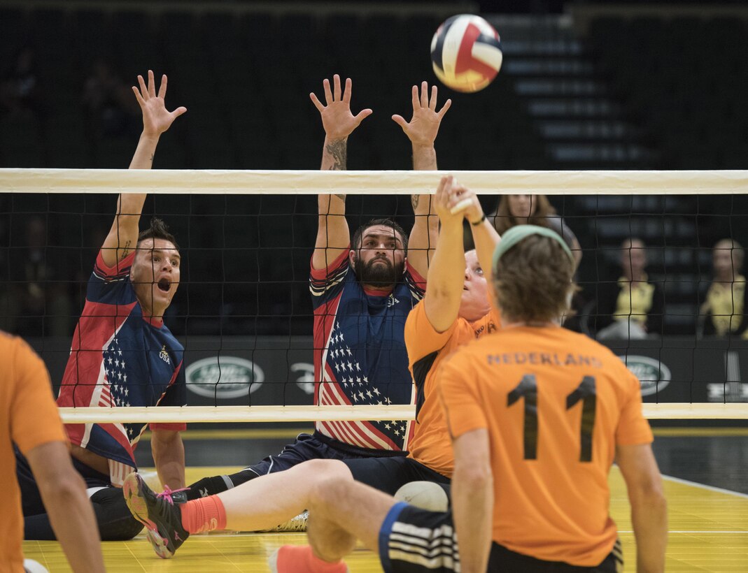 Army veteran Nicholas Titman, left, and Air Force veteran Nicholas Dadgostar prepare to block the ball against the Danish team in a sitting volleyball semifinals match at the 2016 Invictus Games in Orlando, Fla., May 11, 2016. DoD photo by Roger Wollenberg