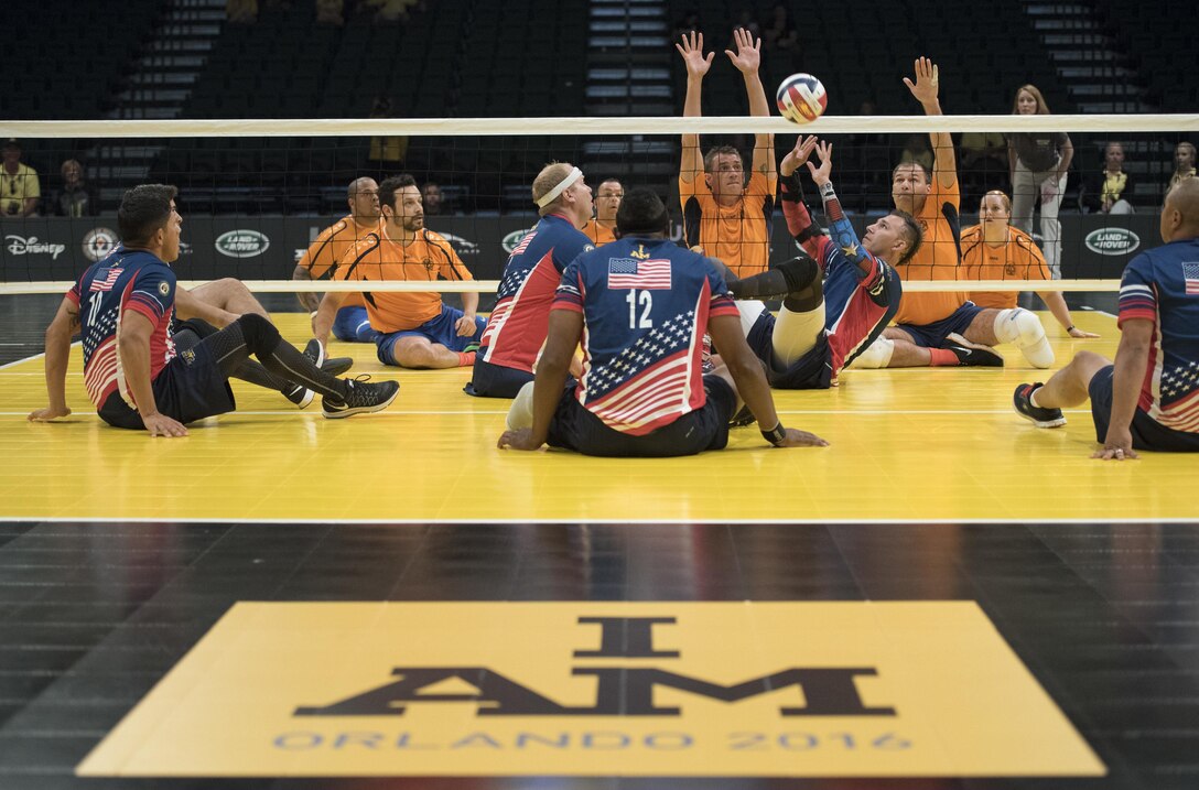 Army veteran Nicholas Titman, center right, prepares to set the ball for a team member in a sitting volleyball semifinals match at the 2016 Invictus Games in Orlando, Fla., May 11, 2016. DoD photo by Roger Wollenberg