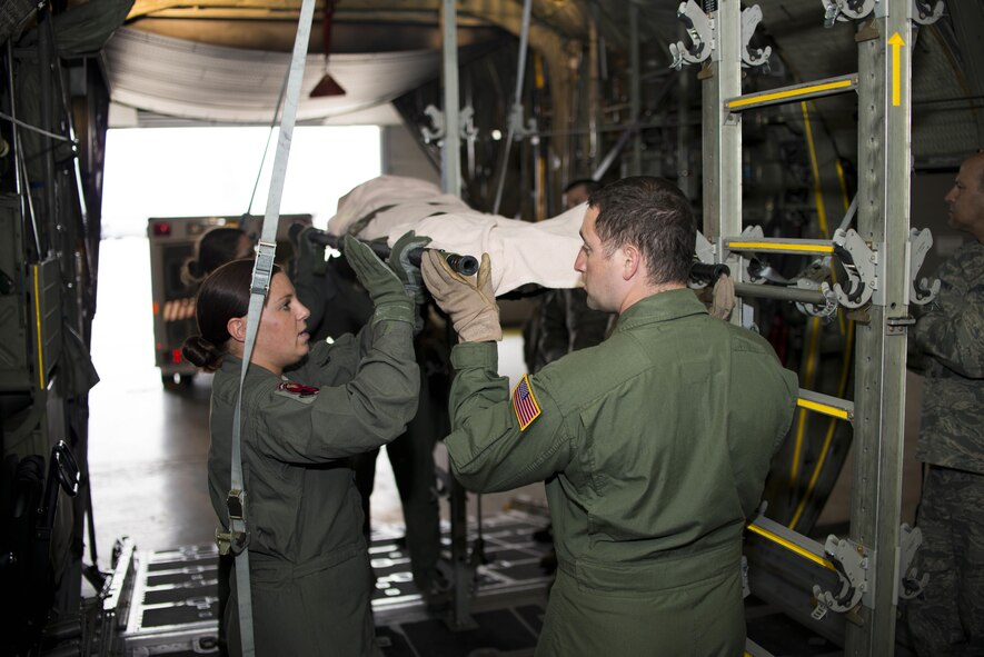 Members of the 914th Aeromedical Evacuation Squadron simulate loading a patient onto a C-130 Hercules during an exercise, May 2, 2016, Niagara Falls Air Reserve Station, N.Y. The joint exercise took place with the 914th Aeromedical Staging Squadron as part of annual training requirements. (Photo by U.S. Air Force Tech. Sgt. Stephanie Sawyer/released)