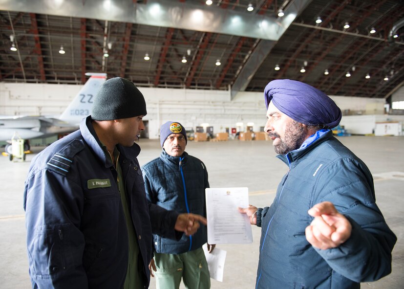 Squadron Leader Latish Palakkot (left), an engineering officer from the Indian Air Force, 14 Fighter Squadron, Ambala Air Base, India, works to approve a repair with his airmen on a Jaguar attack jet aircraft April 29, 2016, at Eielson Air Force Base, Alaska. The 42 airmen from the unit kept their jets in top working order while participating in RED FLAG-Alaska 16-1, a Pacific Air Forces command directed field training exercise for U.S. and allied forces, to provide joint offensive counter-air, interdiction, close air support and large force employment training in a simulated combat environment. (U.S. Air Force photo by Staff Sgt. Shawn Nickel/Released)