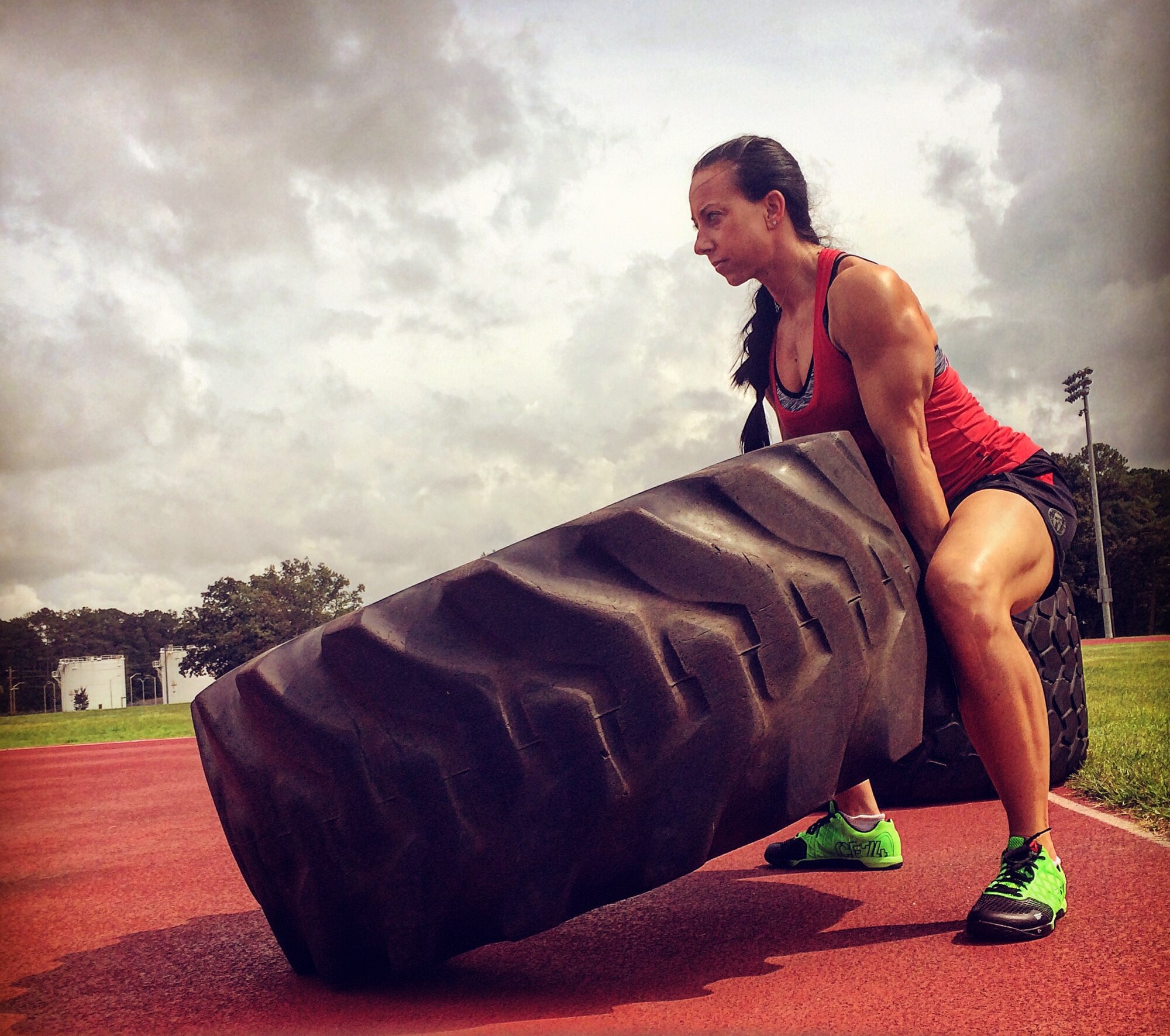 Capt. Leslie Newton, 4th Fighter Wing special victim’s counselor, lifts a tire during a workout, Sept. 6, 2015, at Seymour Johnson Air Force Base, North Carolina. During her early years as a competitive athlete, Newton blew her knees four times, but even now strives to better herself at the gym. (Courtesy photo)
