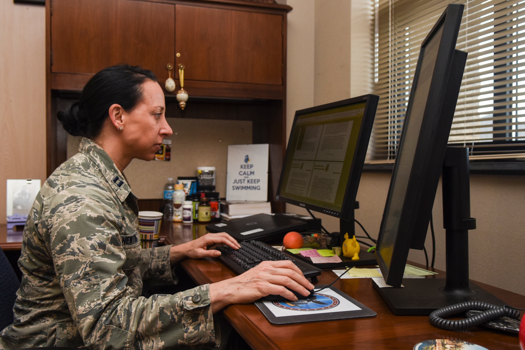 Capt. Leslie Newton, 4th Fighter Wing special victim’s counselor, works at her computer, April 8, 2016, at Seymour Johnson Air Force Base, North Carolina. Newton received her commission into the Judge Advocate General program in May 2013 after more than a decade dedicated to her athletic career. (U.S. Air Force photo by Airman Shawna L. Keyes/Released)