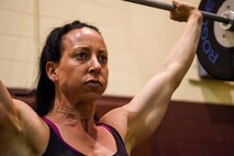 Capt. Leslie Newton, 4th Fighter Wing special victim’s counselor, performs a push press during a workout, April 8, 2016, at Seymour Johnson Air Force Base, North Carolina. In between seeing clients and traveling, Newton finds time to go to the gym and stay competitive in fitness. (U.S. Air Force photo by Airman Shawna L. Keyes/Released)