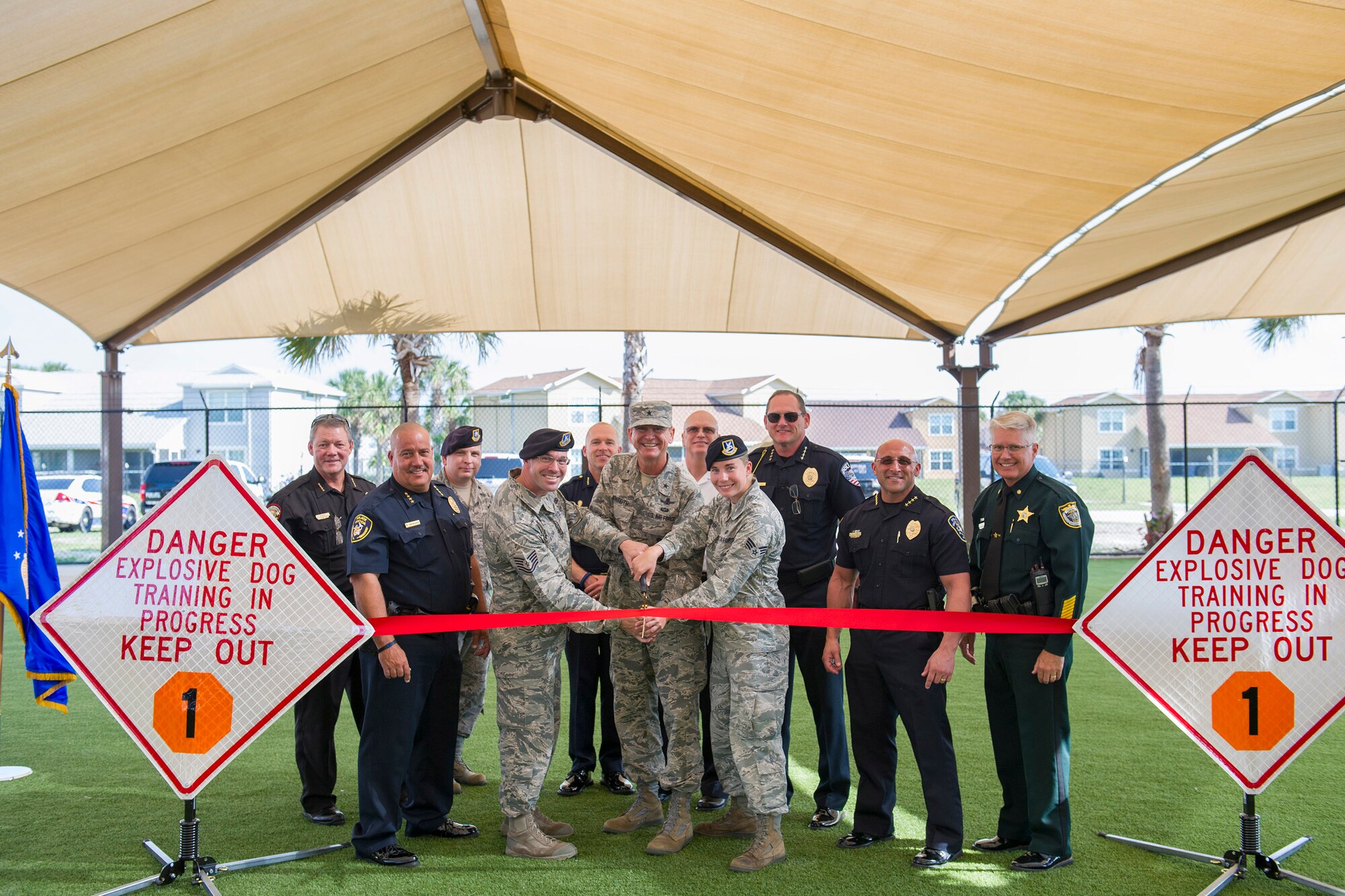 The 45th Security Forces Squadron held a ribbon cutting ceremony to unveil an upgraded military working dog obedience yard at Patrick Air Force Base, Fla., May 11, 2016.The ceremony included a military working dog demonstration and featured Chiefs of Police and local law enforcement K-9 officers from across Brevard County. Among the upgrades include a canopy which lowers the temperature 10 to 20 degrees and keeps the team training year-round all while reducing the impact of rain, sun and heat on our training operations. (U.S. Air Force photos/Matthew Jurgens/Released)