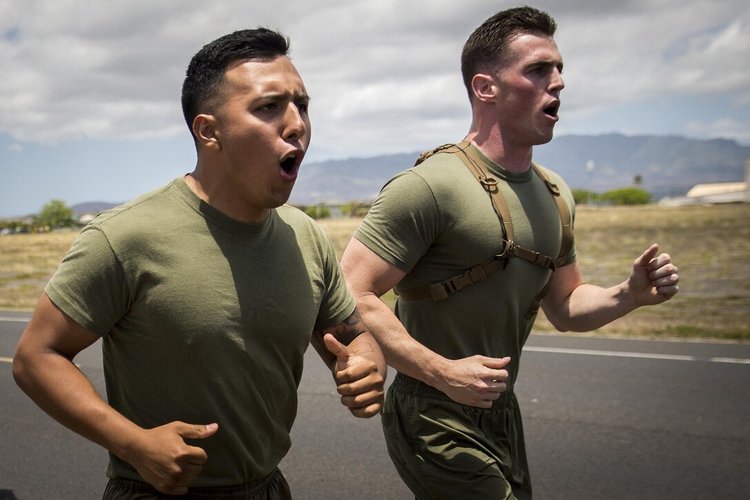 Cpl. Victor Mancilla and Staff Sgt. Christopher Giannetti shout cadence during a first-ever 5K memorial run honoring Cpl. Sara Medina and Lance Cpl. Jacob Hug, aboard Ford Island, Hawaii, May 11, 2016. Marines with U.S. Marine Corps Forces, Pacific and Marine Corps Base Hawaii ran in honor of Medina and Hug, both combat camera Marines, who died one year ago in a helicopter crash while documenting relief efforts in Nepal. Mancilla and Giannetti are both combat camera Marines with MCB Hawaii and MARFORPAC, respectively. (U.S. Marine Corps photo by Sgt. Matthew J. Bragg)