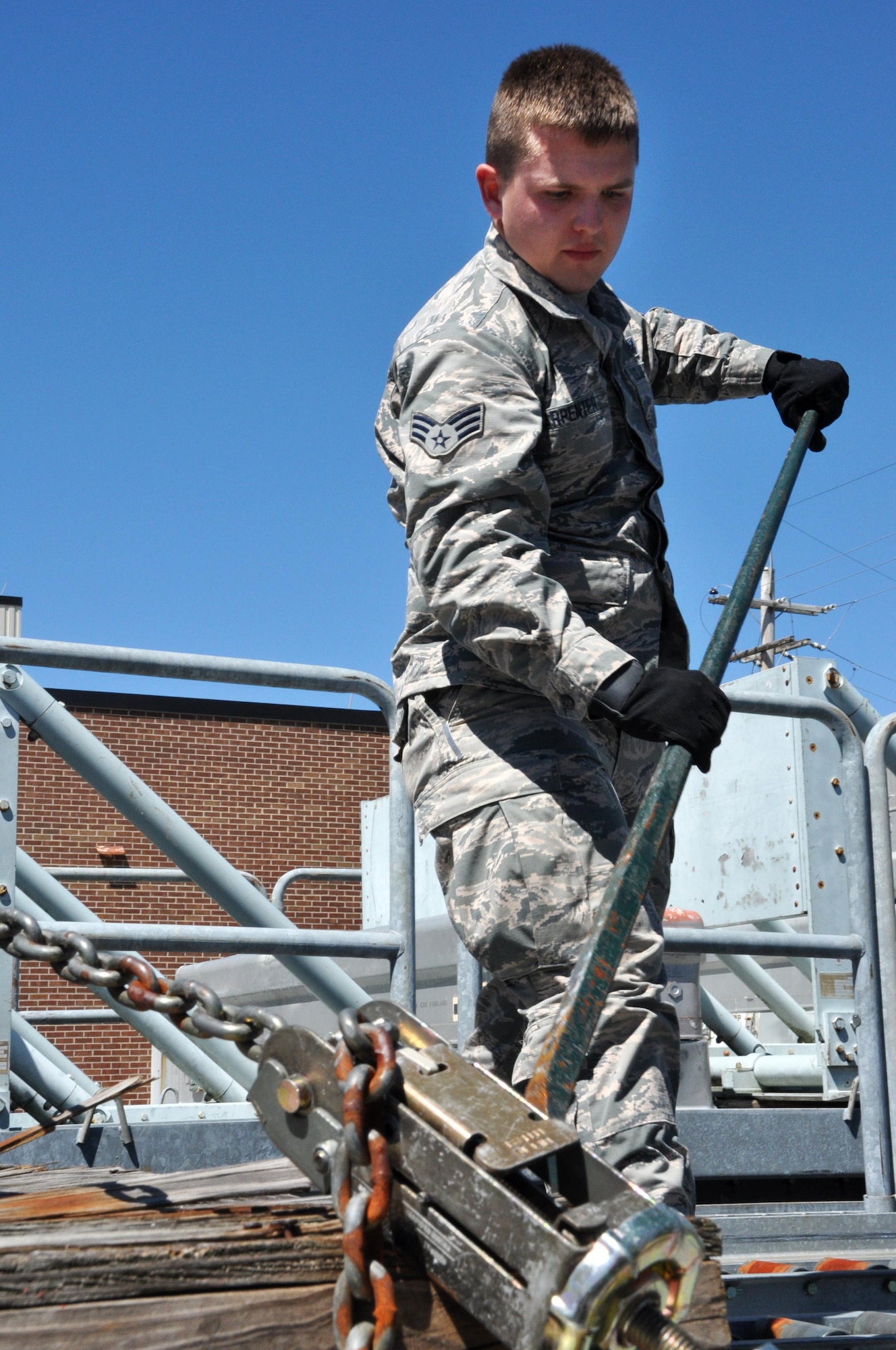Senior Airman Daniel Carpenter, 80th Aerial Port Squadron air transportation journeyman, uses a tool to unjam an obstruction on a track on a loading dock April 3, 2016 at Dobbins Air Reserve Base. Carpenter was accepted into the Air Force Academy and will start training in July 2016.
