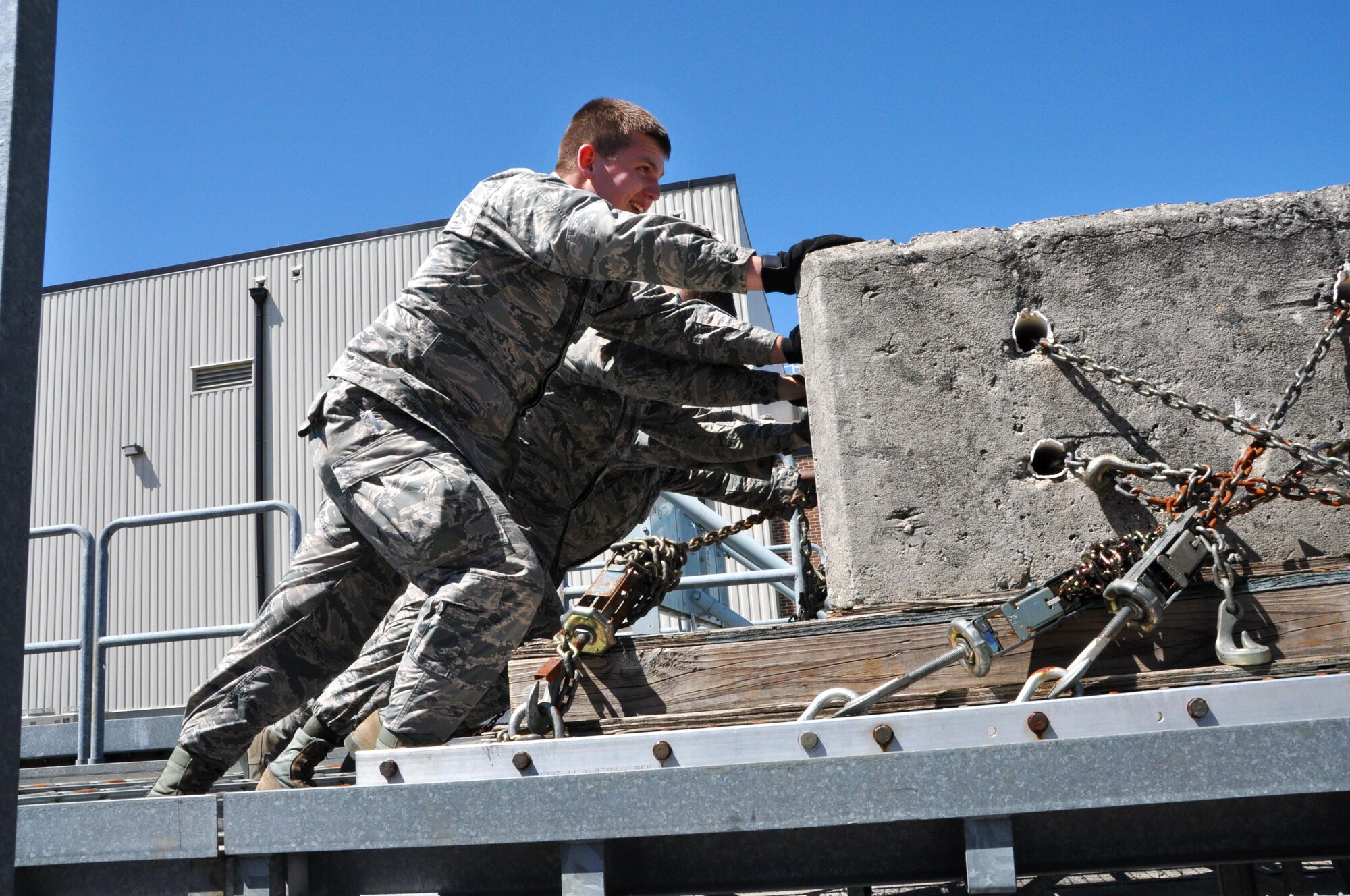 Senior Airman Daniel Carpenter, 80th Aerial Port Squadron air transportation journeyman, works alongside other Airmen to move a large, heavy pallet April 3, 2016 at Dobbins Air Reserve Base. Carpenter recently received the news of his acceptance into the USAFA, military academy for officer candidates for the U.S. Air Force. (U.S. Air Force photo by Senior Airman Lauren Douglas)