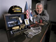 Jim Byers and his memorabilia from Korea.  He didn't fly a sleek F-86 Sabre jet into "MiG Alley" to shoot down enemy planes. In 1952, he was a draftsman, in the Korean War. One of more than 5.7 million "average Joes" who served there. 
But he left his mark and helped the Air Force win the air war.  "There was no glamour. I drew charts and flipped them at briefings," he said. "But I knew I was helping do something important."
At the time of the photo, he still believed that 49 years later. Proud of his one-year stint in Korea, he can still recall the little details of his tour. 

Once stateside, he noticed a "beautiful gal in a tight yellow sweater" who he says made his eyes pop out. She was to become Mrs. Kathryn Byers. 

In 1959 he got out to start his family. They had four children and got to use his G.I. Bill to for his bachelor's and master's degrees in mechanical engineering, and then began work for the Navy in 1963.

The Byerses retired to Jamison, Pa., and have four grandchildren.
(U.S. Air Force photo/Tech. Sgt. Lance Cheung)