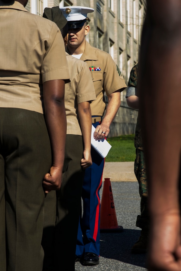 Sergeant Phillip Voss, canvassing recruiter with Recruiting Substation North Boston, Massachusetts, poses Marine Corps knowledge questions to a cadet of the Lynn English High School Junior Reserve Officer Training Corps during a cadet inspection, May 11, 2016. Marine recruiters from the area inspected the high school's cadets in preparation for upcoming JROTC drill competitions.
