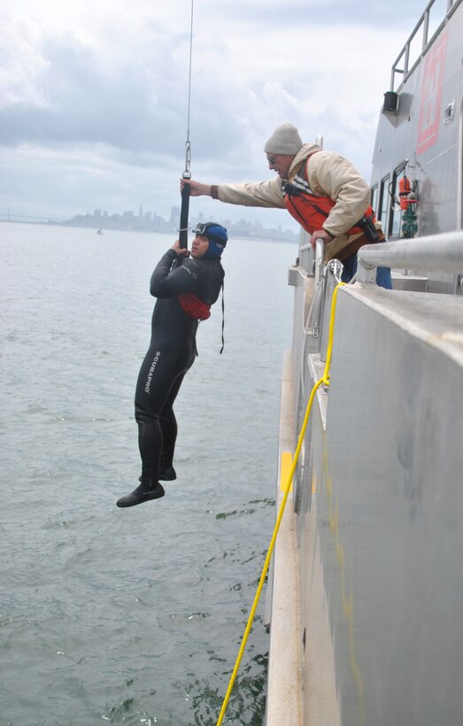 Steve Rohner, right, a crewmember of the M/V John A. B. Dillard, Jr., assists Nicholas Cimaglio onto deck May 5. The Dillard crew conducted three days of rescue swimmer training in the San Francisco Bay May 3-5.