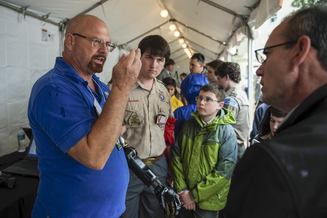 Johnny Matheny demonstrates how a modular prosthetic limb works during DARPA Demo Day 2016 at the Pentagon, May 11, 2016. Matheny is a one arm amputee and test subject with Johns Hopkins Applied Physics Lab. DoD photo by Marine Corps Sgt. Drew Tech