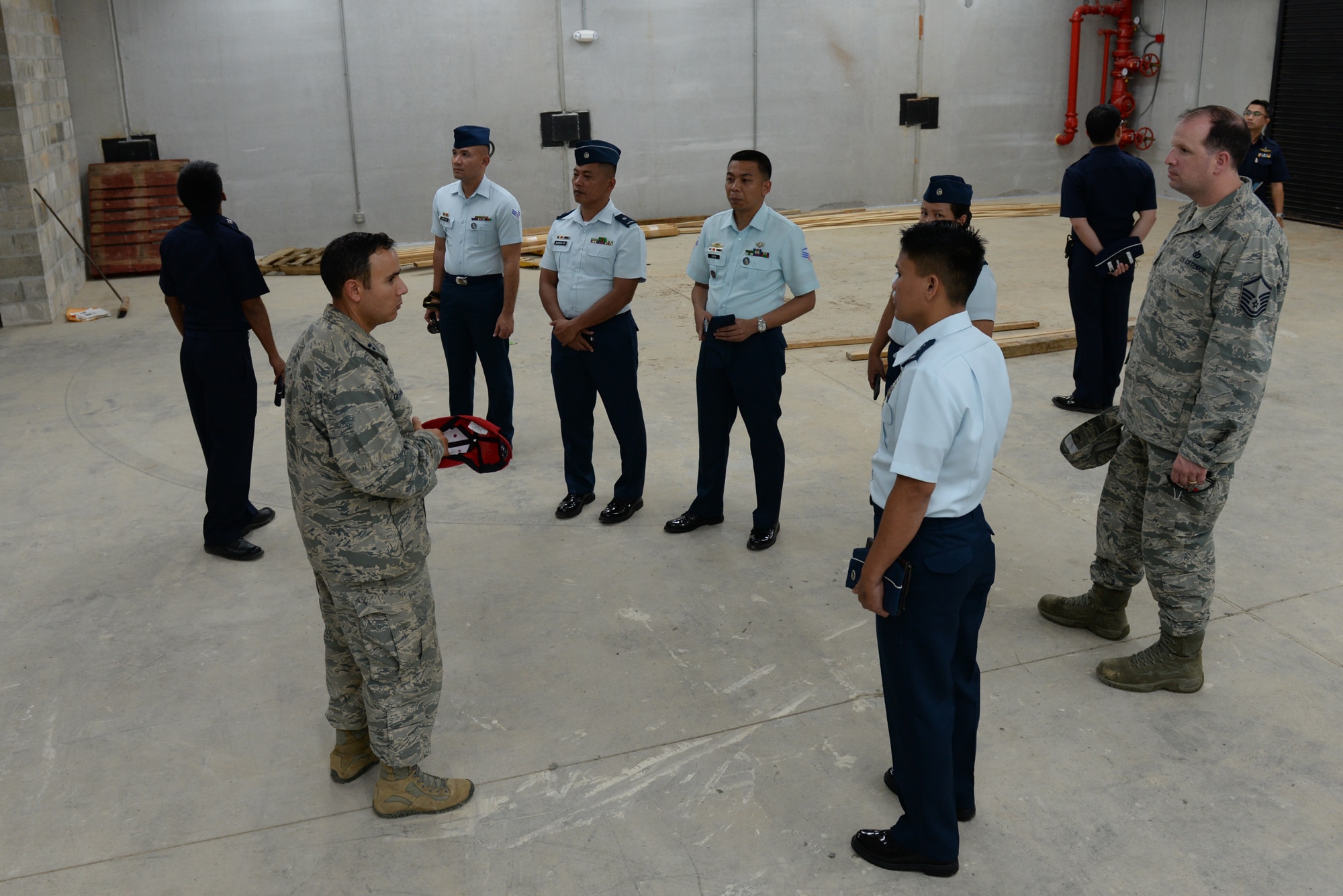 Participants of a Pacific Unity multilateral tilt-up construction workshop tour a facility built with the tilt-up construction method May 10, 2016, at Andersen Air Force Base, Guam. Pacific Unity engagements facilitate the building of military partnerships, building capacity, and increasing interoperability among the U.S. Air Force and participating nations. Tilt-up construction is a building technique that uses concrete panels which are made horizontally on the ground and then tilted up into their vertical position at the building site. (U.S. Air Force photo by Airman 1st Class Jacob Skovo)
