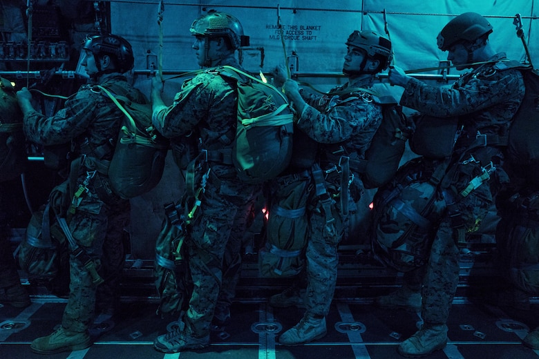 Marines with the 3rd Marine Division, 3rd Reconnaissance Battalion, wait for jump orders on a C-130 Hercules over Yokota Air Base, Japan, May 11, 2016. The training ensures that jumpers are ready to deploy throughout the Indo-Asia Pacific region. (U.S. Air Force photo by Senior Airman Delano Scott/Released)