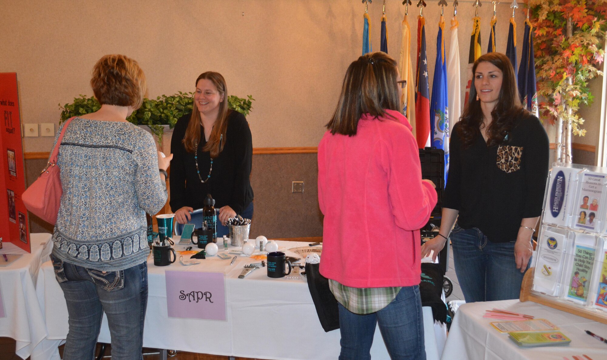 Attendees of Ladies Night Out speak with Sexual Assault Prevention and Response representatives April 29, 2016, at Eielson Air Force Base, Alaska. SAPR was among several vendors that came out to answer health and wellness questions. (U.S. Air Force photo by Capt. Abigail Rose/Released)