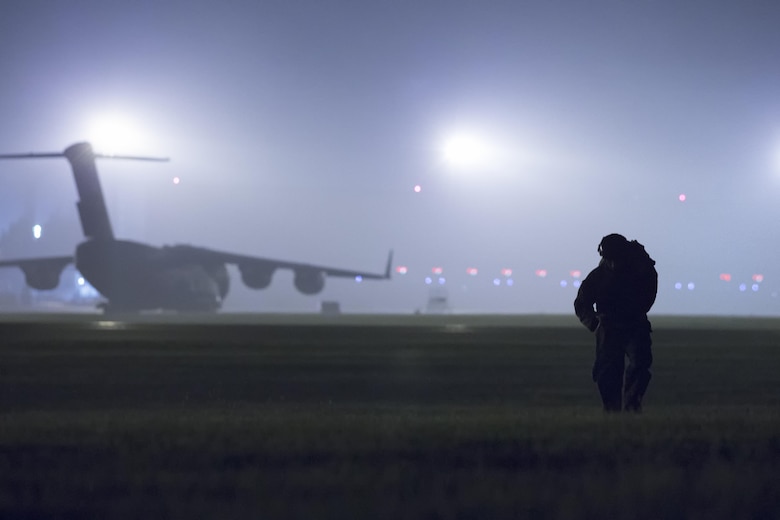 A U.S. Marine from the 3rd Reconnaissance Battalion, 3rd Marine Division, III Marine Expeditionary Force carries his parachute after landing at Yokota Air Base, Japan, May 11, 2016, during Jump week. The training not only allowed the Marines to practice jumping, but it also allowed the Yokota aircrews to practice flight tactics and timed-package drops. (U.S. Air Force photo by Yasuo Osakabe/Released) 