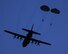 U.S. Marines from the 3rd Reconnaissance Battalion, 3rd Marine Division, III Marine Expeditionary Force drop from a U.S. Air Force C-130 Hercules, assigned to 36th Airlift Squadron at Yokota Air Base, Japan, May 11, 2016 during Jump Week. The training not only allowed the Marines to practice jumping, but it also allowed the Yokota aircrews to practice flight tactics and timed-package drops. (U.S. Air Force photo by Yasuo Osakabe/Released) 