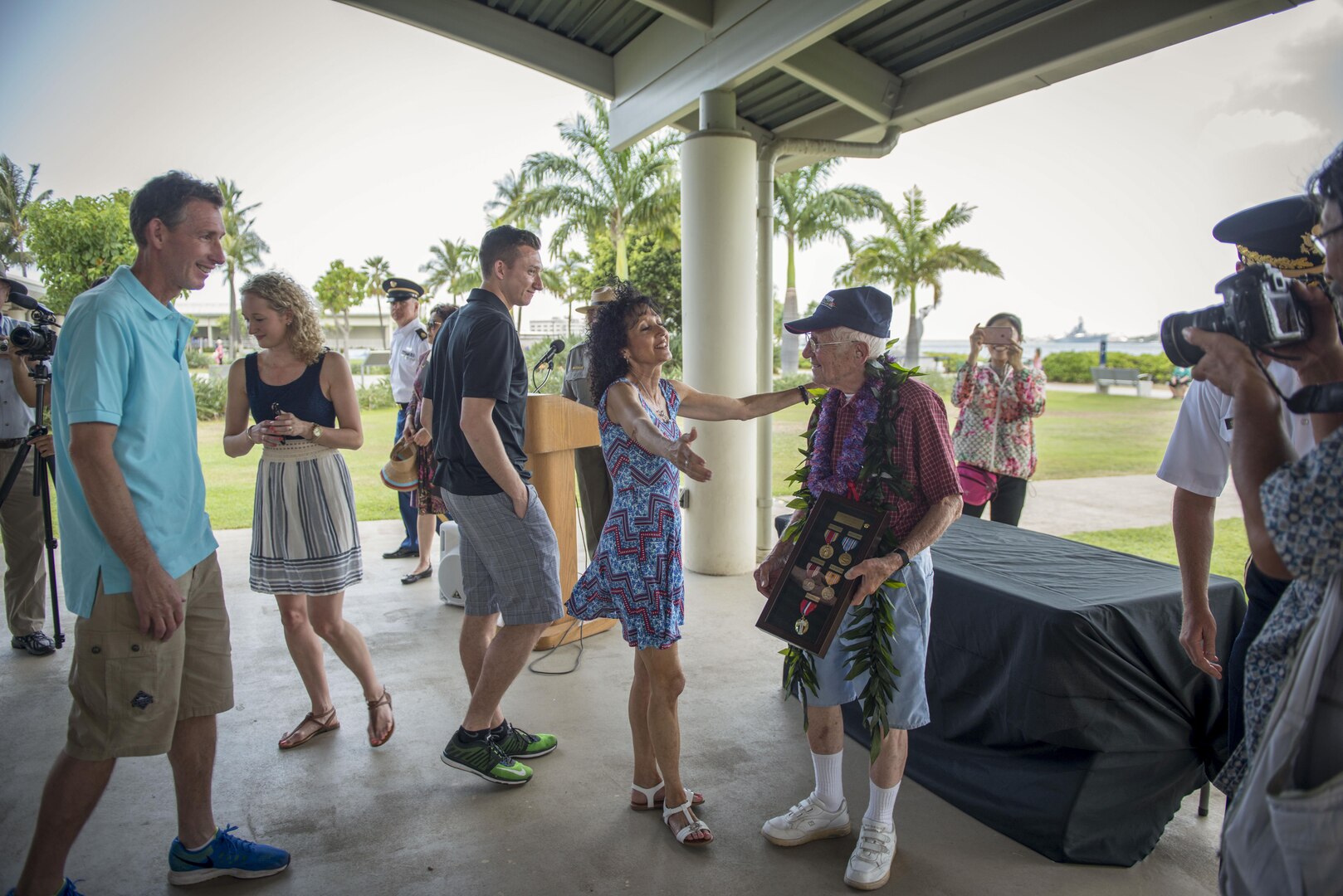 Charles Wolf, a World War ll veteran, and his only daughter, Jill Eilert, hug after a surprise ceremony held in Wolf's honor, at the Pearl Harbor Education Center, Hawaii, May 6, 2016. After 72 years, Wolf was finally awarded his numerous medals and awards for his selfless service to this nation. DPAA's mission is to provide the fullest possible accounting for our missing personnel to their families and the nation. (DoD photo by MC2 Aiyana Paschal/RELEASED)
