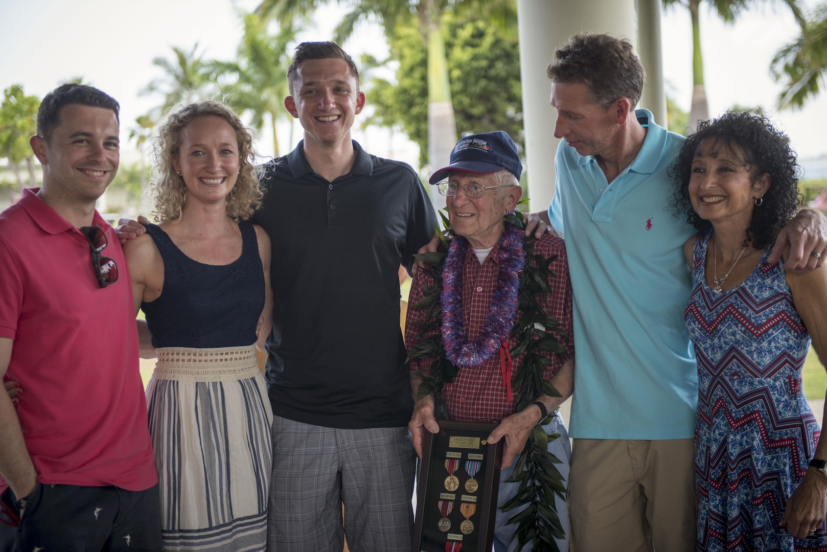 Charles Wolf, a World War ll veteran, stands with his family at the Pearl Harbor Education Center, Hawaii, May 6, 2016. Wolf was a part of a surprise ceremony held in his honor, where he was presented a shadow box containing awards and medals he had never received during his service in the U.S. Army, 72 years ago. The awards were presented by Brig. Gen. Mark Spindler, Deputy Director of the Defense POW/MIA Accounting Agency (DPAA), in an official ceremony, to thank Wolf for all the sacrifices he made to this country so many years ago. DPAA's mission is to provide the fullest possible accounting for our missing personnel to their families and the nation. (DoD photo by MC2 Aiyana Paschal/RELEASED)
