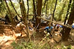 U.S. Air Force Tech. Sgt. Brett Majesky passes a broom to Army Staff Sgt. Benjamin Bishop  during a Defense POW/MIA Accounting Agency recovery mission in To Mo Rong District, Kun Tum Province, Socialist Republic of Vietnam, March 28, 2016. DPAA teammates deployed to the area in hopes of recovering the remains of a pilot unaccounted-for from the Vietnam War.  The mission of DPAA is to provide the fullest possible accounting for our missing personnel to their families and the nation.  (DoD photo by U.S. Army Sgt. Richard DeWitt/Released)