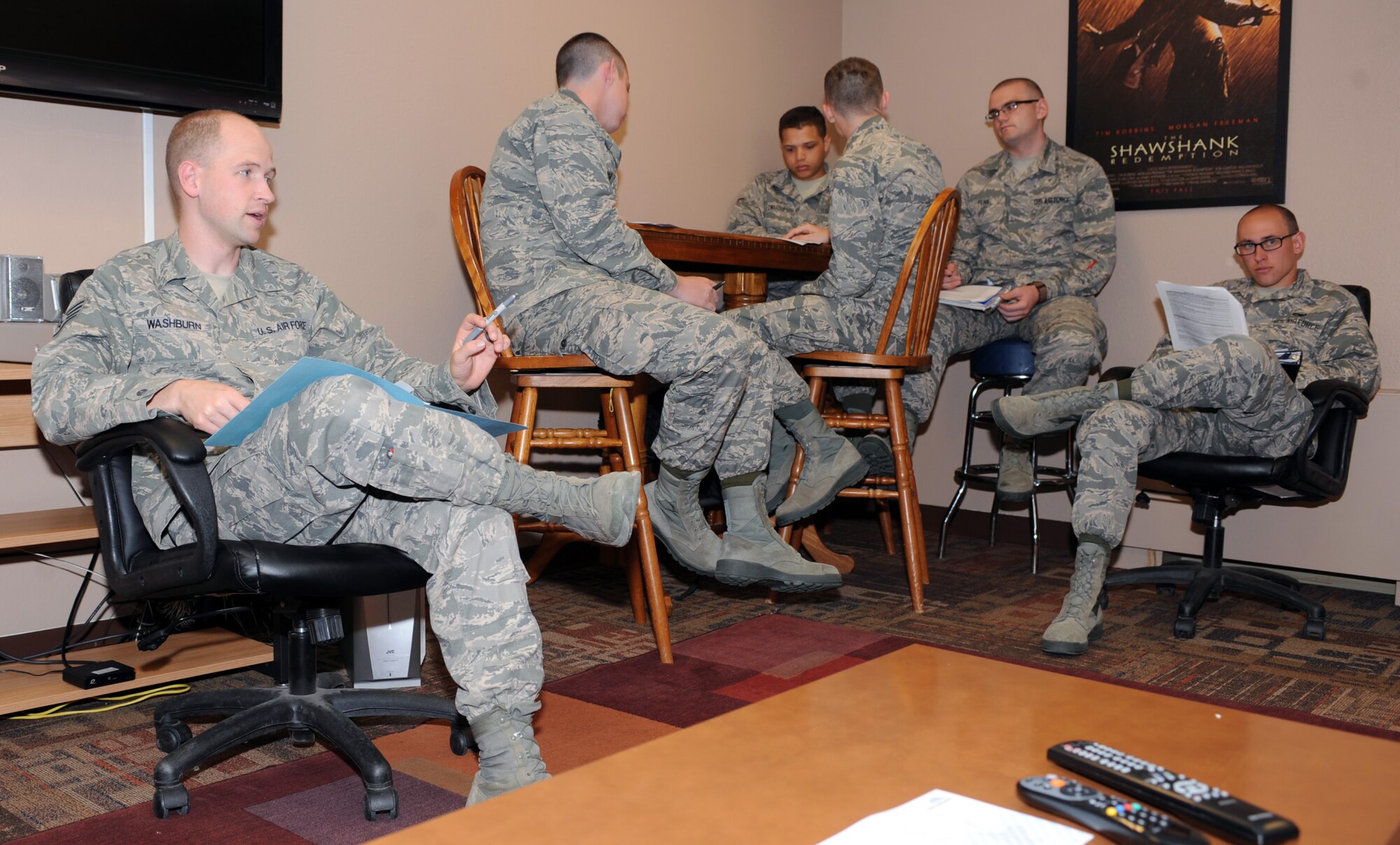 Staff Sgt. Alex Washburn, 28th Civil Engineer Squadron airman dorm leader, gives a dorm in-processing brief to a group of new Airmen at Ellsworth Air Force Base, S.D., April 13, 2016. The ADLs ensure new first term Airmen arriving at Ellsworth receive this brief to understand the rules and policies of living in the dormitories, including restrictions on having guests and the types of authorized pets in the dorms. (U.S. Air Force photo by Airman 1st Class Denise M. Nevins/Released)
