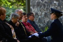 Maj. Amanda Turcotte, McChord Field Honor Guard officer in charge, presents Denis Sprague, surviving son of Airman Second Class Conrad Sprague, with the U.S. flag during an honors ceremony May 10, 2016, at Tahoma National Cemetery in Kent, Wash. For the last 63 years Sprague has been missing in action until earlier this year when his remains were identified by the Armed Forces Medical Examiner at Dover Air Force Base, Del. (U.S. Air Force photo/Senior Airman Jacob Jimenez) 