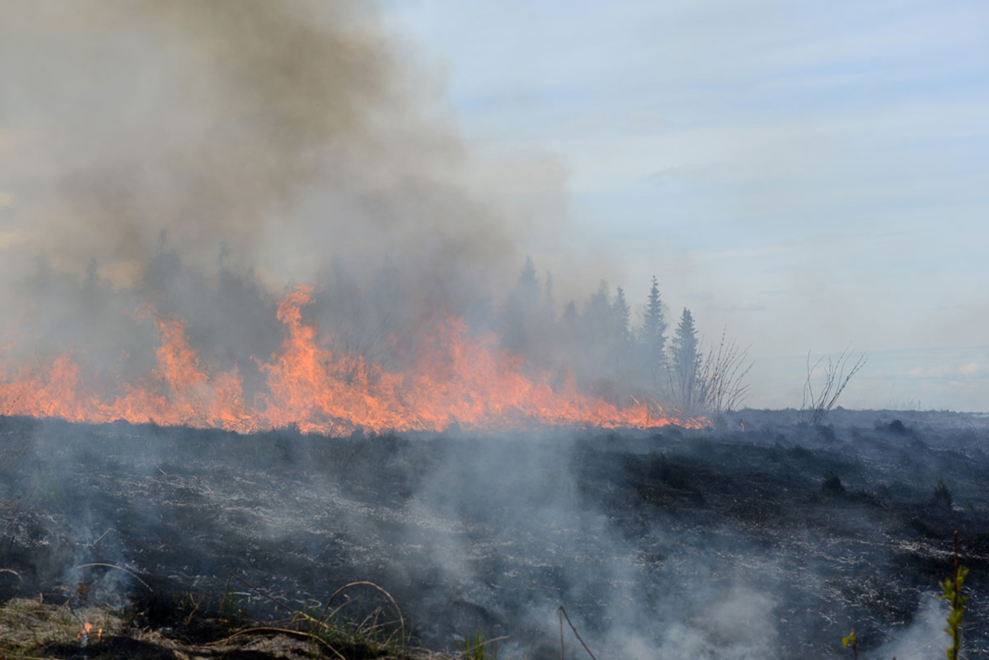 Members from the Alaska Division of Forestry and Joint Base Elmendorf-Richardson Fire Department start burning approximately 1,700 acres of military training grounds including firing ranges and drop zones in a prescribed burn at JBER, Alaska, May 2, 2016. According to the National Oceanic and Atmospheric Administration, last winter in Alaska was the second warmest on record dating back to 1925. Combined with record-low snowfall and precipitation, the chance of fire activity greatly increases as combustible dry detritus accumulates. Controlled burns reduce the chance of spot fires by removing excess dry brush and grass. (U.S. Air Force photo by Airman 1st Class Christopher R. Morales)