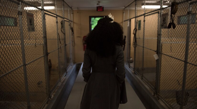 Kinosha Soden, Mrs. DC America and military spouse, walks through an 11th Security Forces Squadron military working dog kennel during a base tour at Joint Base Andrews, Md., May 11, 2016. Soden spent three years as a member of the DC-based, non-profit organization “Sweethearts for Soldiers,” helping enhance the lives of military men and women. (U.S. Air Force photo by Airman 1st Class Philip Bryant) 