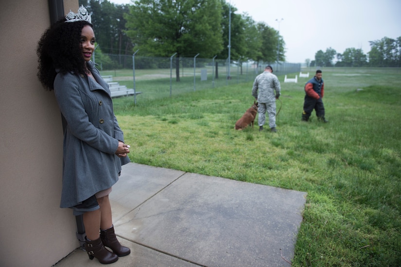 Kinosha Soden, Mrs. DC America and military spouse, watches an 11th Security Forces Squadron military working dog demonstration during a base tour at Joint Base Andrews, Md., May 11, 2016. Soden will represent the District of Columbia and will compete for the Mrs. America title. (U.S. Air Force photo by Airman 1st Class Philip Bryant) 