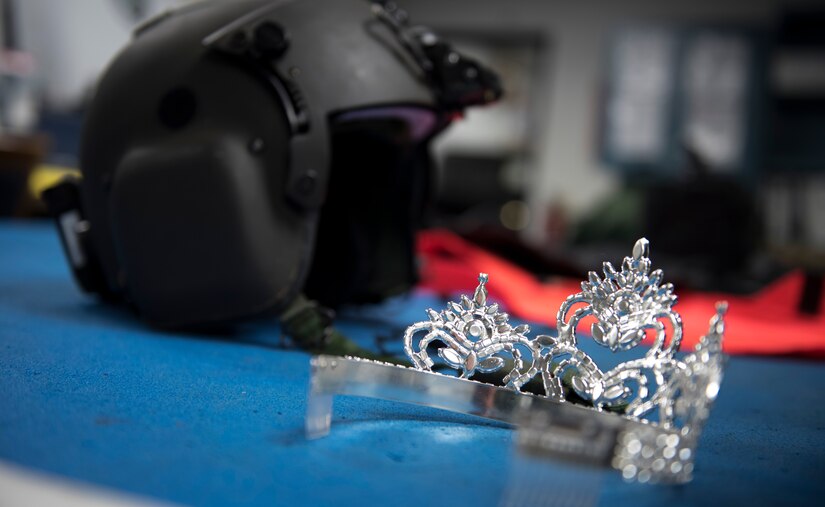 Kinosha Soden, Mrs. DC America and military spouse, sits her tiara next to a 1st Helicopter Squadron flight helmet during a base tour at Joint Base Andrews, Md., May 11, 2016. Soden will represent the District of Columbia and will compete for the Mrs. America title. (U.S. Air Force photo by Airman 1st Class Philip Bryant) 