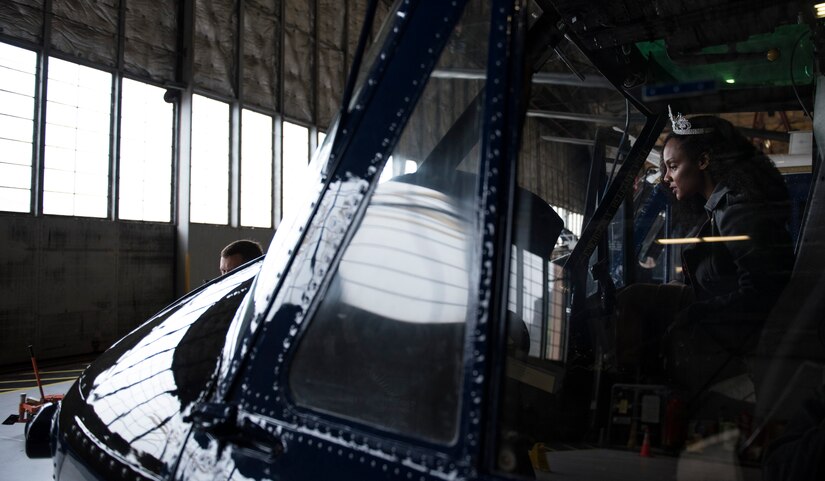 Kinosha Soden, Mrs. DC America and military spouse, sits in the cockpit of a 1st Helicopter Squadron UH-1N Iroquois during a base tour at Joint Base Andrews, Md., May 11, 2016. Soden toured the base to familiarize herself with the operations and mission of the base. (U.S. Air Force photo by Airman 1st Class Philip Bryant)