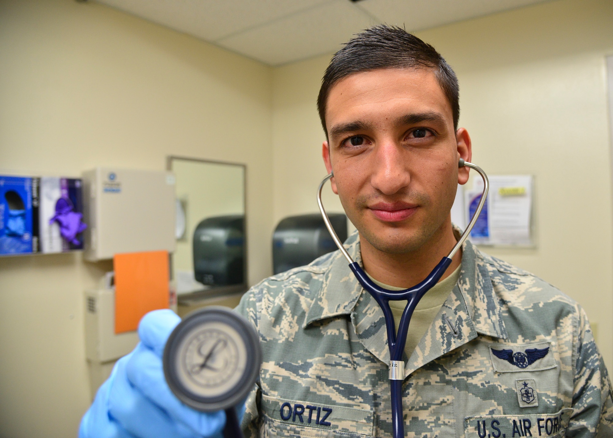 Staff Sgt. Alexander Ortiz, 341st Medical Operations Squadron aerospace medical technician, simulates the use of the stethoscope May 11, 2016, at Malmstrom Air Force Base, Mont. Ortiz has been selected to commission and become a physician assistant through the Interservice Physician Assistant Program. (U.S. Air Force photo/Airman Daniel Brosam)