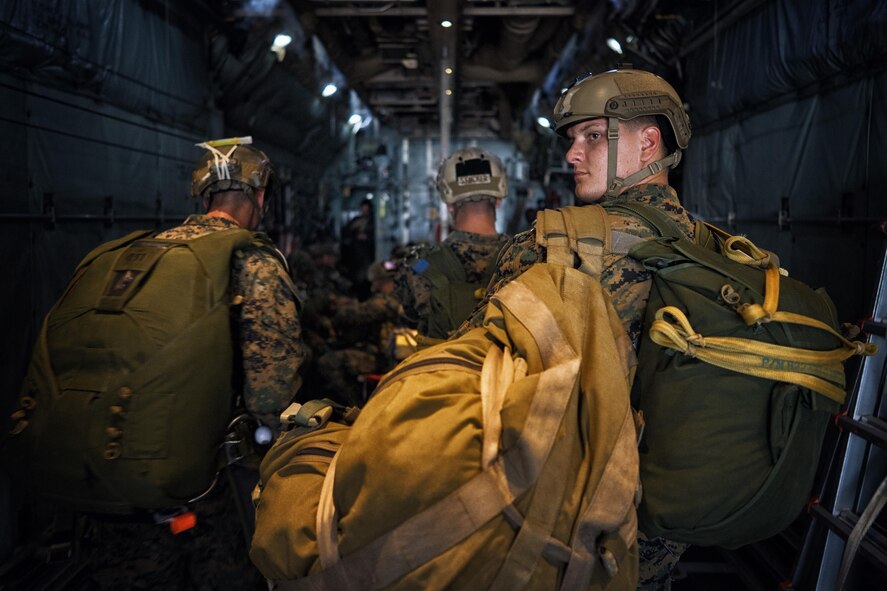 Marines with the 3rd Reconnaissance Battalion, 3rd Marine Division, III Marine Expeditionary Force, board a C-130 Hercules for jump training at Yokota Air Base, Japan, May 11, 2016. The training allowed Marines to practice jumping while also allowing Yokota aircrews to practice flight tactics and timed-package drops. (U.S. Air Force photo by Senior Airman Delano Scott/Released)