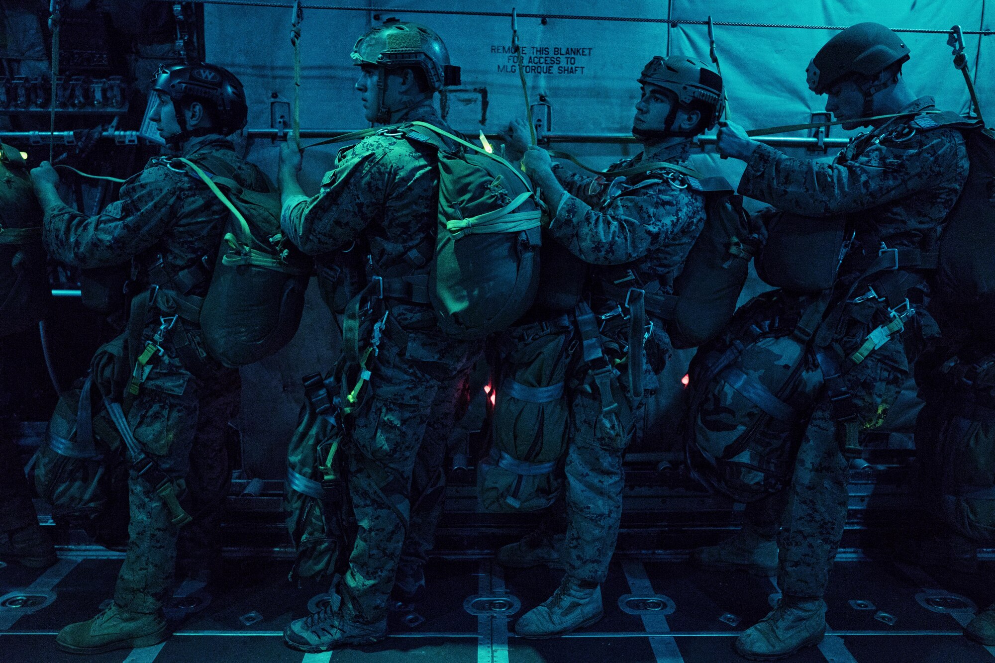 Marines with the 3rd Marine Division, 3rd Reconnaissance Battalion, wait for jump orders on a C-130 Hercules over Yokota Air Base, Japan, May 11, 2016. The training ensures that jumpers are ready to deploy throughout the Indo-Asia Pacific region. (U.S. Air Force photo by Senior Airman Delano Scott/Released)