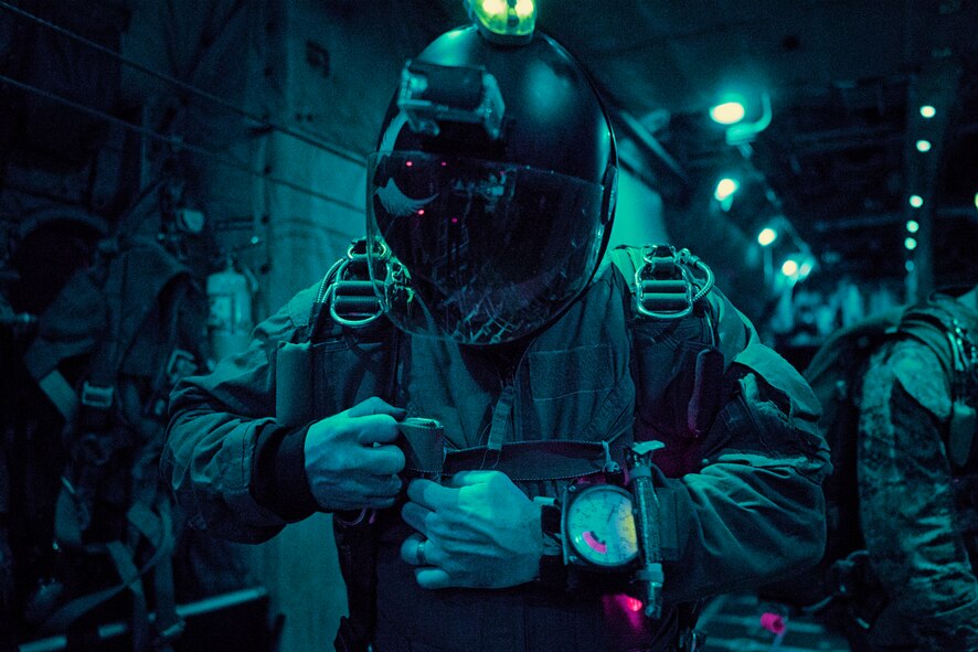 A Marine with the 3rd Reconnaissance Battalion, 3rd Marine Division, III Marine Expeditionary Force, prepares to jump out of a C-130 Hercules over Yokota Air Base, Japan, May 11, 2016. The Marines were supported by the aircrew and aircraft assigned to the 36th Airlift Squadron. (U.S. Air Force photo by Senior Airman Delano Scott/Released)