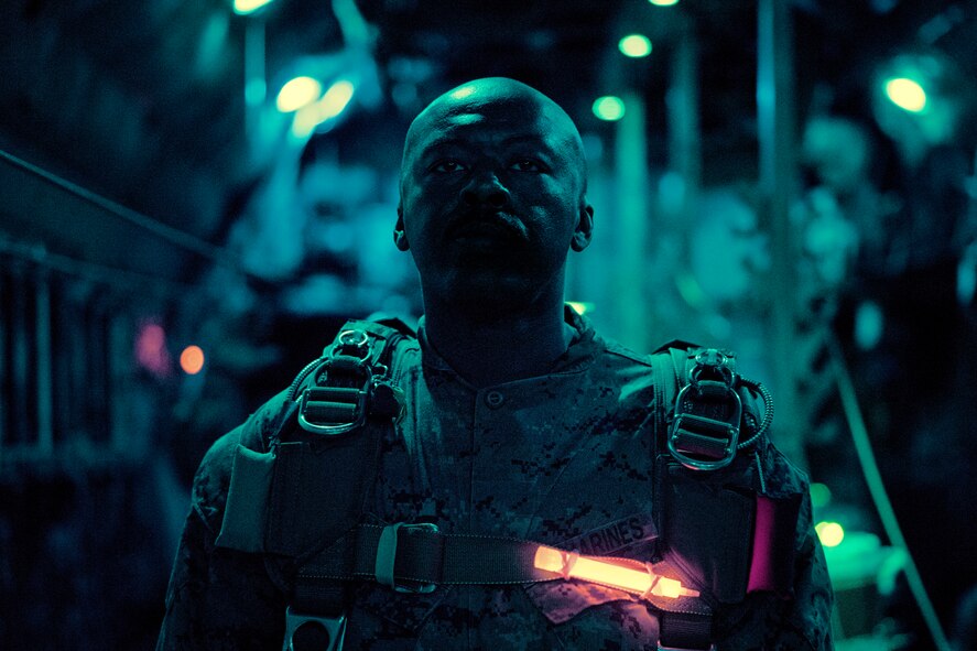 A Marine with the 3rd Reconnaissance Battalion, 3rd Marine Division, III Marine Expeditionary Force, prepares to jump out of a C-130 Hercules over Yokota Air Base, Japan, May 11, 2016. The unit spent the week working on their parachute qualifications practicing static line and high-altitude, low-opening jumps. (U.S. Air Force photo by Senior Airman Delano Scott/Released)