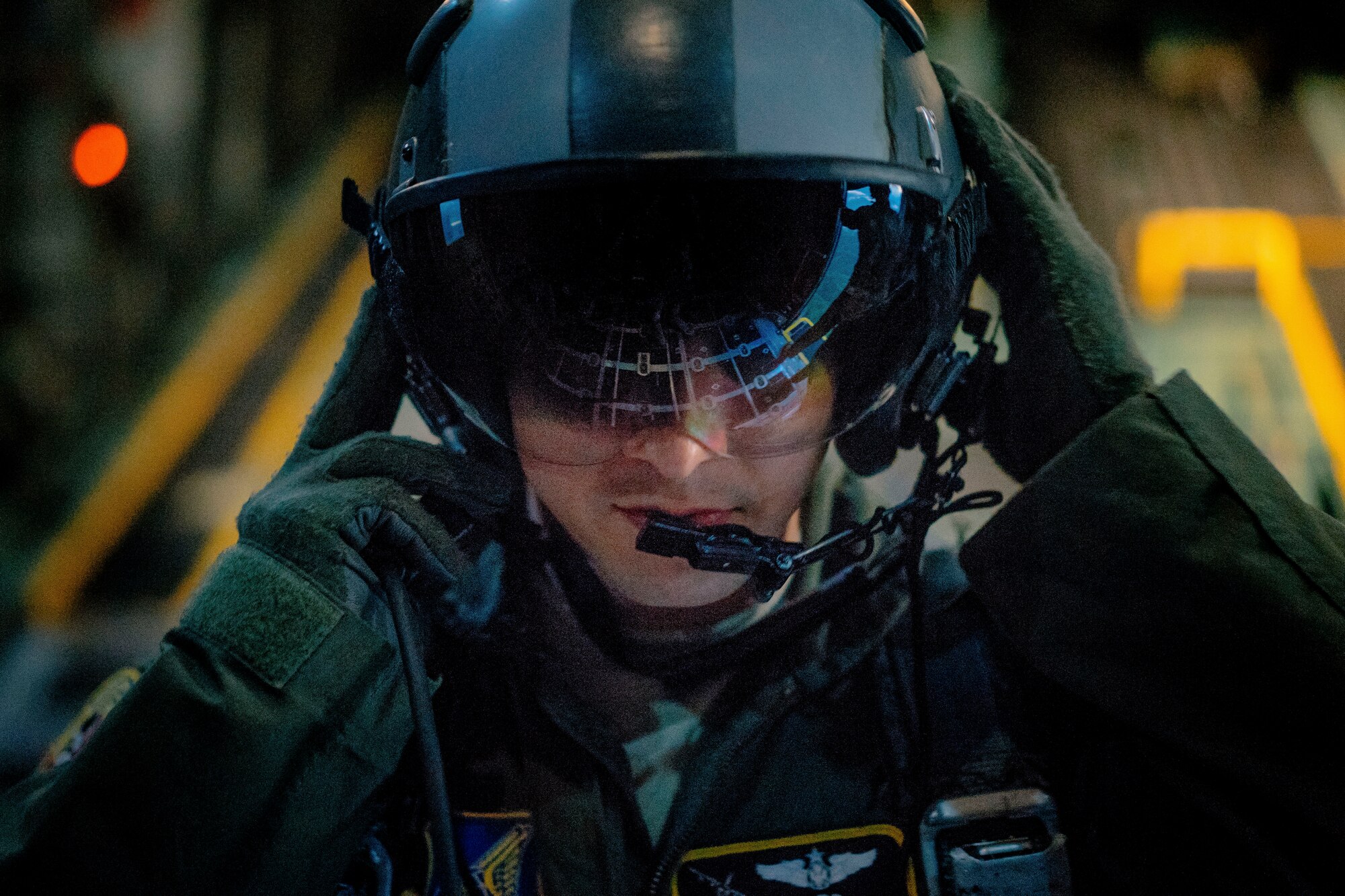 Staff Sgt. Nickolas Alarcon, 36th Airlift Wing instructor loadmaster, communicates drop times with C-130 Hercules pilots during a night jump at Yokota Air Base, Japan, May 11, 2016. The training allowed Marines to practice jumping while also allowing Yokota aircrews to practice flight tactics and timed-package drops. (U.S. Air Force photo by Senior Airman Delano Scott/Released)