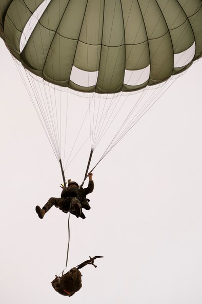 A U.S. Marine from the U.S. Marine Corps from the 3rd Reconnaissance Battalion, 3rd Marine Division, III Marine Expeditionary Force descends to the drop zone after exiting from an Air Force C-130 Hercules, assigned to 36th Airlift Squadron, at Yokota Air Base, Japan, May 11, 2016, during Jump week. The training not only allowed the Marines to practice jumping, but it also allowed the Yokota aircrews to practice flight tactics and timed-package drops. (U.S. Air Force photo by Yasuo Osakabe/Released)   
