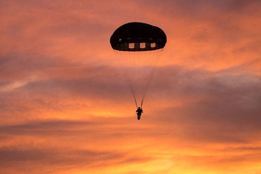 A U.S. Marine from the U.S. Marine Corps from the 3rd Reconnaissance Battalion, 3rd Marine Division, III Marine Expeditionary Force descends to the drop zone after exiting from an Air Force C-130 Hercules, assigned to 36th Airlift Squadron, at Yokota Air Base, Japan, May 11, 2016, during Jump week. The training not only allowed the Marines to practice jumping, but it also allowed the Yokota aircrews to practice flight tactics and timed-package drops. (U.S. Air Force photo by Yasuo Osakabe/Released)   