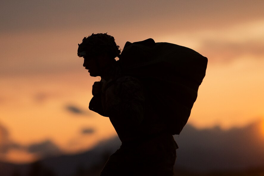 U.S. Marine Cpl. Joshua Coulter, 3rd Reconnaissance Battalion, 3rd Marine Division, III Marine Expeditionary Force carries his parachute after landing at Yokota Air Base, Japan, May 11, 2016, during Jump week. The training not only allowed the Marines to practice jumping, but it also allowed the Yokota aircrews to practice flight tactics and timed-package drops. (U.S. Air Force photo by Yasuo Osakabe/Released)   