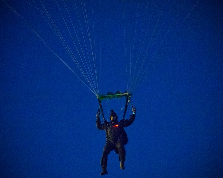 A U.S. Marine from the U.S. Marine Corps from the 3rd Reconnaissance Battalion, 3rd Marine Division, III Marine Expeditionary Force descends to the drop zone after exiting from an Air Force C-130 Hercules, assigned to 36th Airlift Squadron, at Yokota Air Base, Japan, May 11, 2016, during Jump week. The training not only allowed the Marines to practice jumping, but it also allowed the Yokota aircrews to practice flight tactics and timed-package drops. (U.S. Air Force photo by Yasuo Osakabe/Released)     