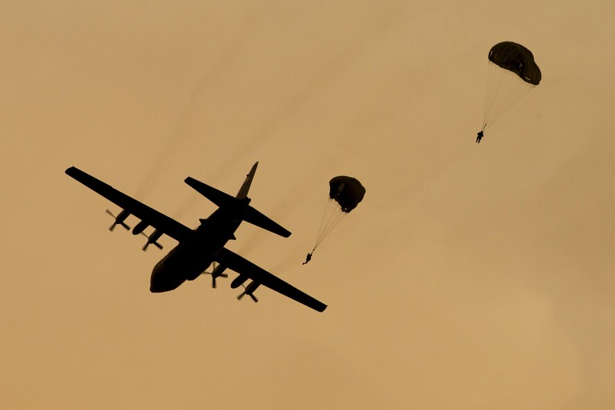 U.S. Marines from the 3rd Reconnaissance Battalion, 3rd Marine Division, III Marine Expeditionary Force drop from a U.S. Air Force C-130 Hercules, assigned to 36th Airlift Squadron at Yokota Air Base, Japan, May 11, 2016. The training not only allowed the Marines to practice jumping, but it also allowed the Yokota aircrews to practice flight tactics and timed-package drops. (U.S. Air Force photo by Yasuo Osakabe/Released)   