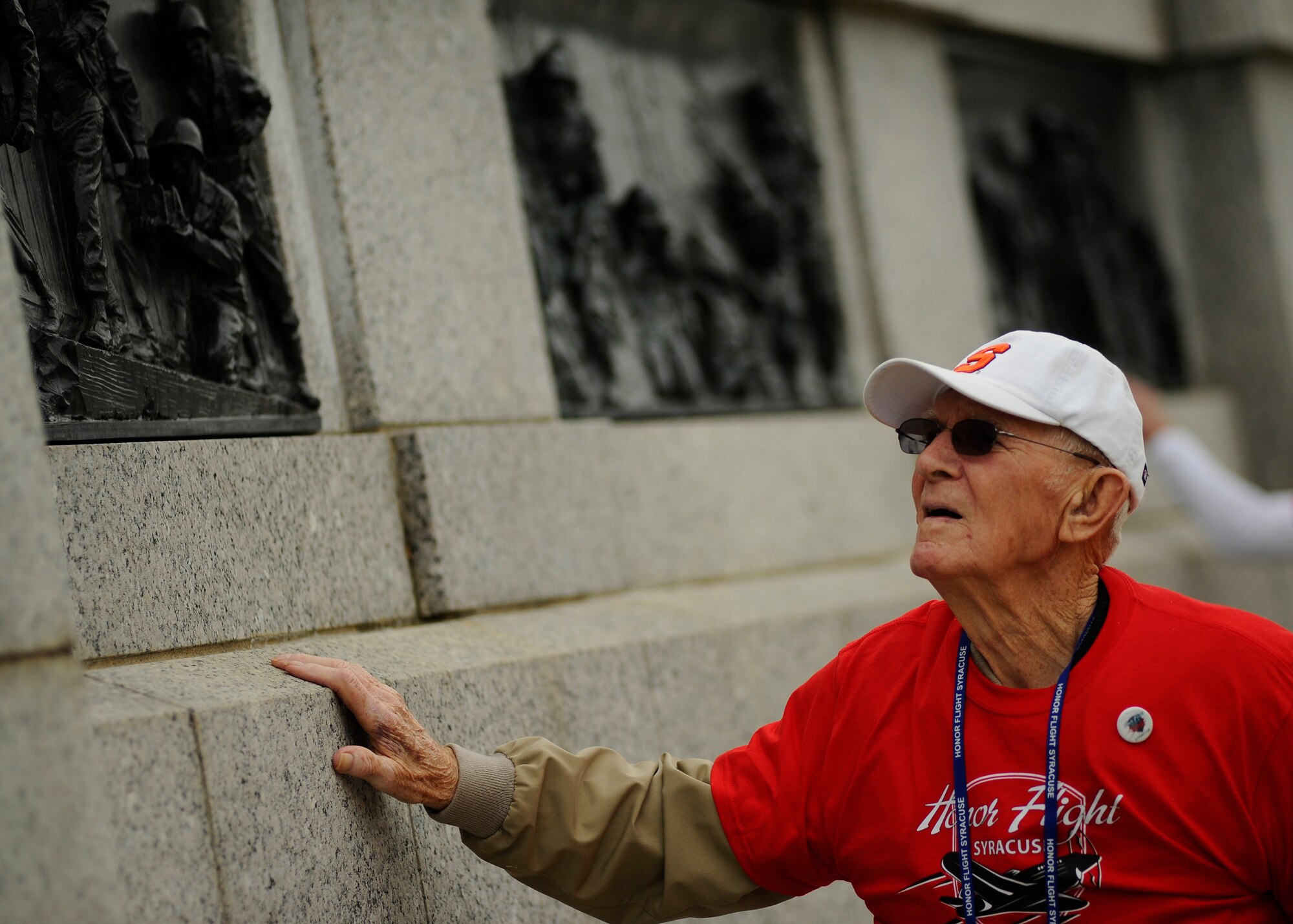 Paul Bowker, a World War II Army veteran, views the bronze artwork depicting the battles fought during World War II as he heads to the heart of the National World War II Memorial in Washington, D.C., April 30, 2016. Bowker is part of the Honor Flight Network’s Syracuse flight. (U.S. Air Force photo/Tech. Sgt. Bryan Franks)