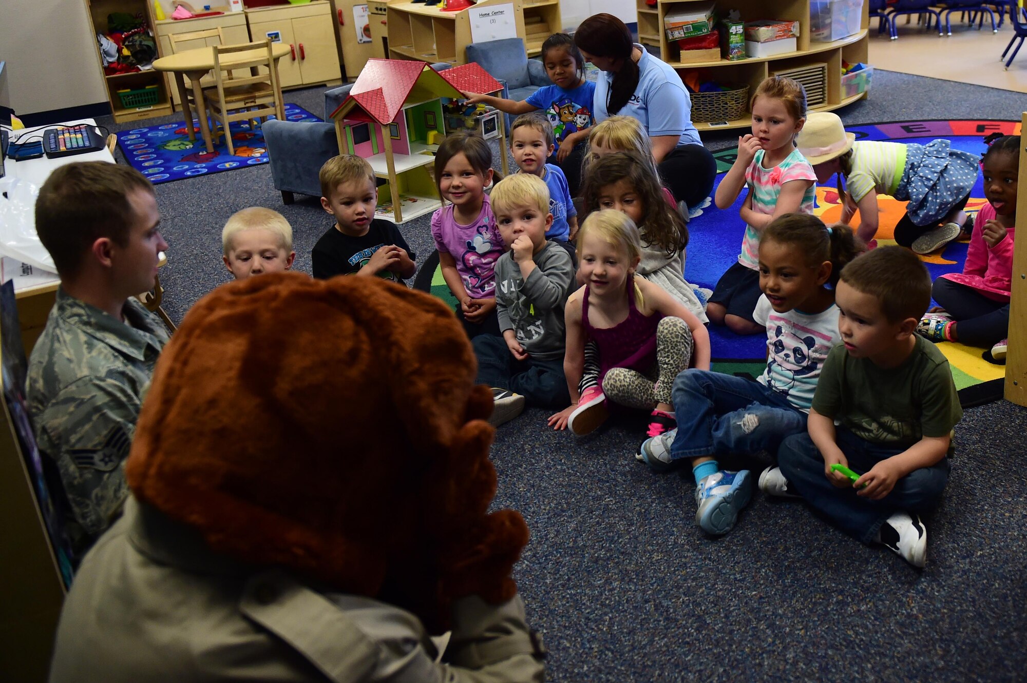 Buckley Air Force Base children interact with McGruff the Crime Dog May 9, 2016, at the Crested Butte Child Development Center on Buckley AFB, Colo. McGruff visited with children in honor of Police Week, which pays tribute to those who protect and serve as police officers. (U.S. Air Force photo by Airman 1st Class Gabrielle Spradling/Released) 